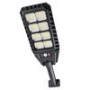 Соларна LED лампа 2400W DRAGON, монтирана на стена и осветяваща двор през нощта.